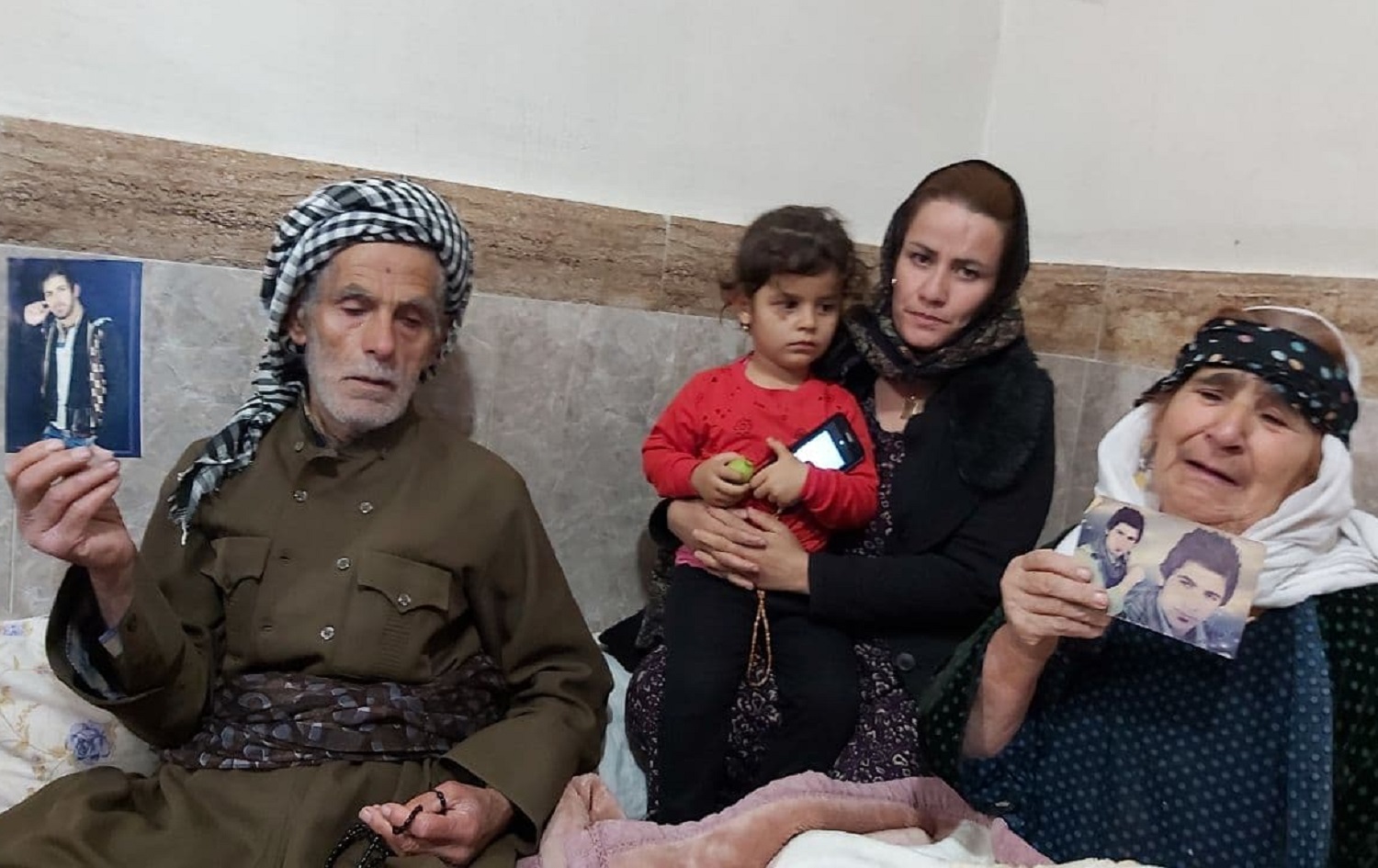 Ahmed’s father (left), wife, daughter and mother mourn for him in his home village of Dashti, Sardasht on November 20, 2020. Photo: Jabar Dastbaz/ Rudaw